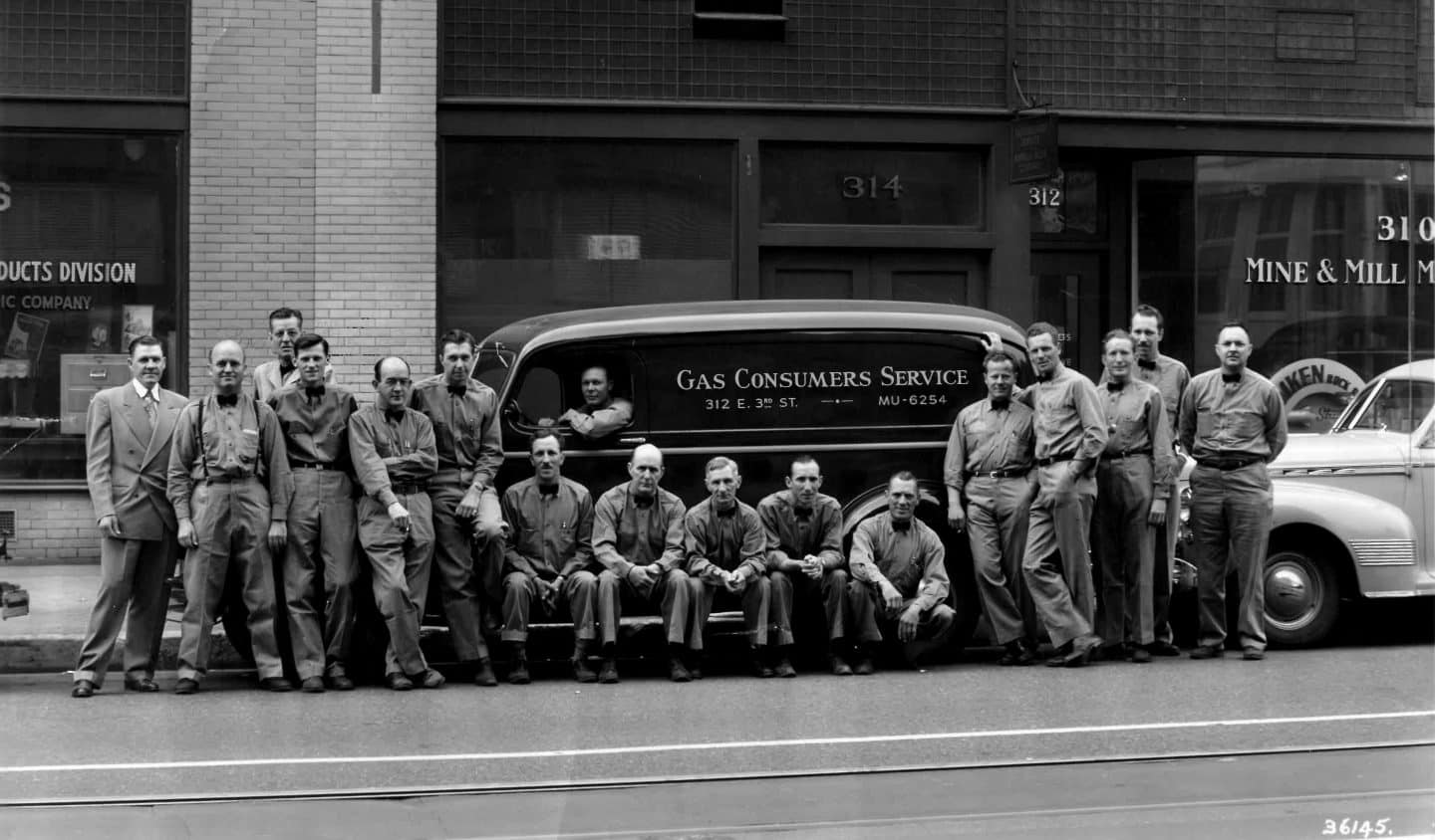 Gas Consumers Service employees posing by an old work van
