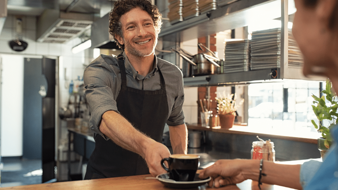 Man serving coffee to customer