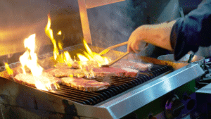 chef cooking on commercial grill